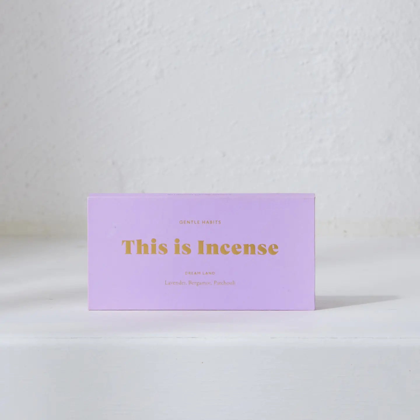 Purple Dreamland incense box with open sticks on a neutral background