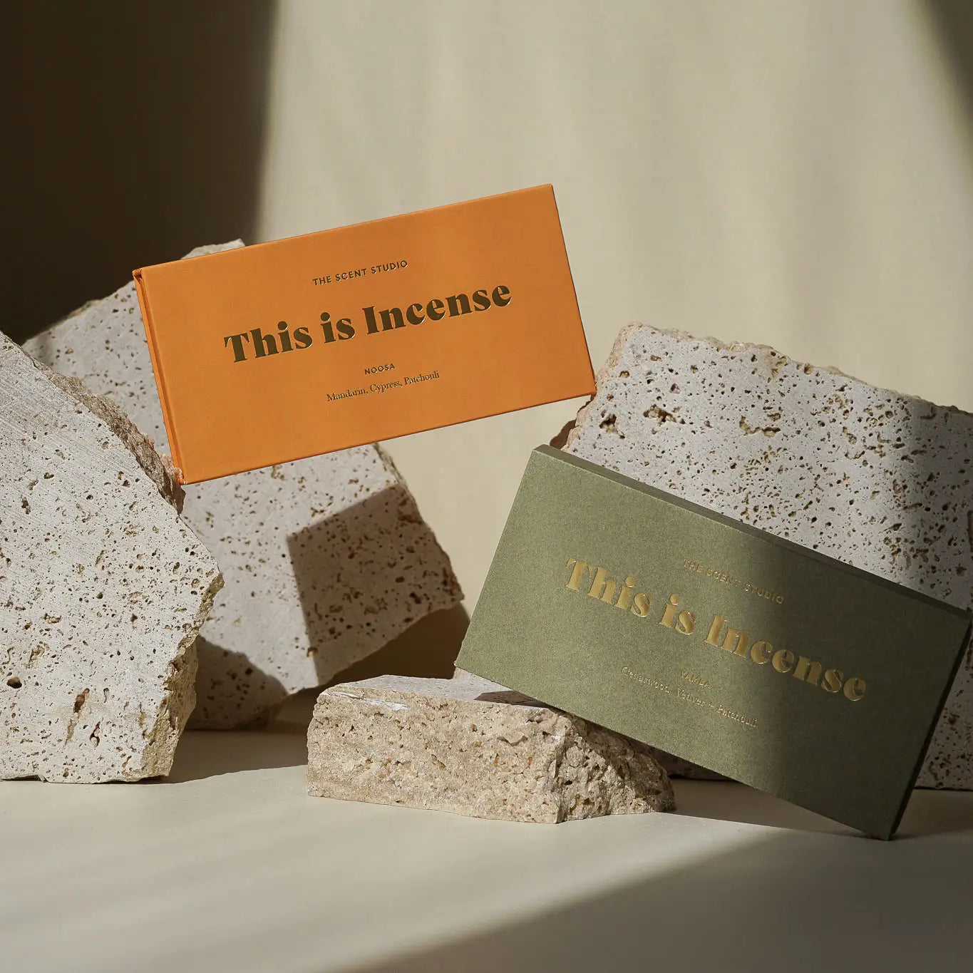 “Yamba incense box with brown incense sticks on a neutral background”