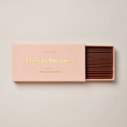 Minimalist Byron Bay incense box in blush pink with open incense sticks displayed.