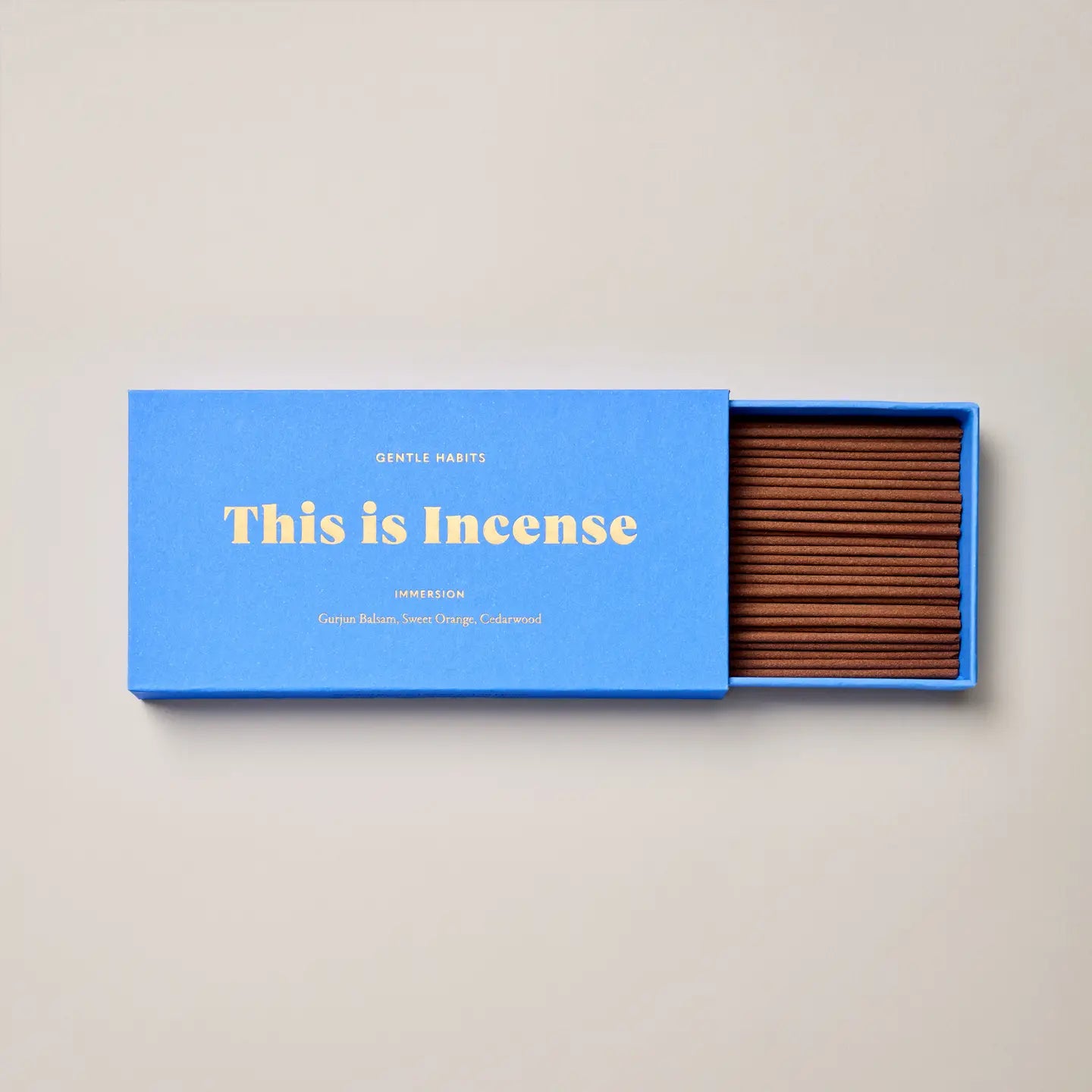 Open Immersion incense box showing neatly arranged brown incense sticks inside a blue box