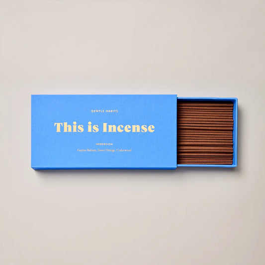 Open Immersion incense box showing neatly arranged brown incense sticks inside a blue box