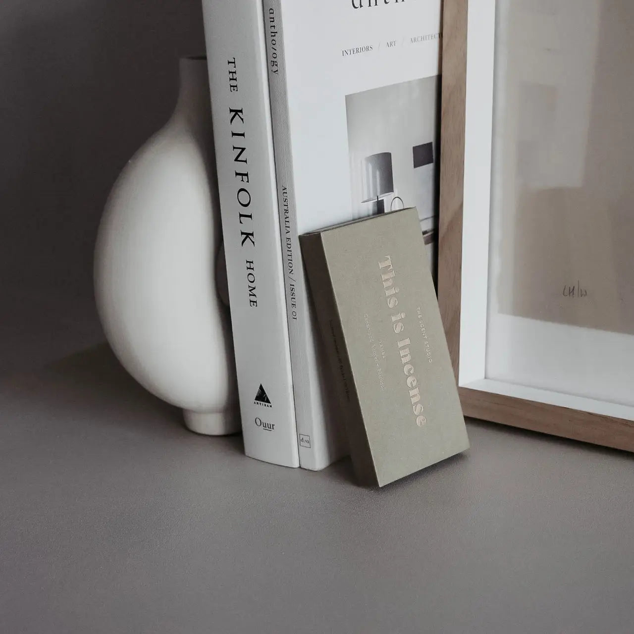 “Yamba incense box styled beside white ceramic decor and books”