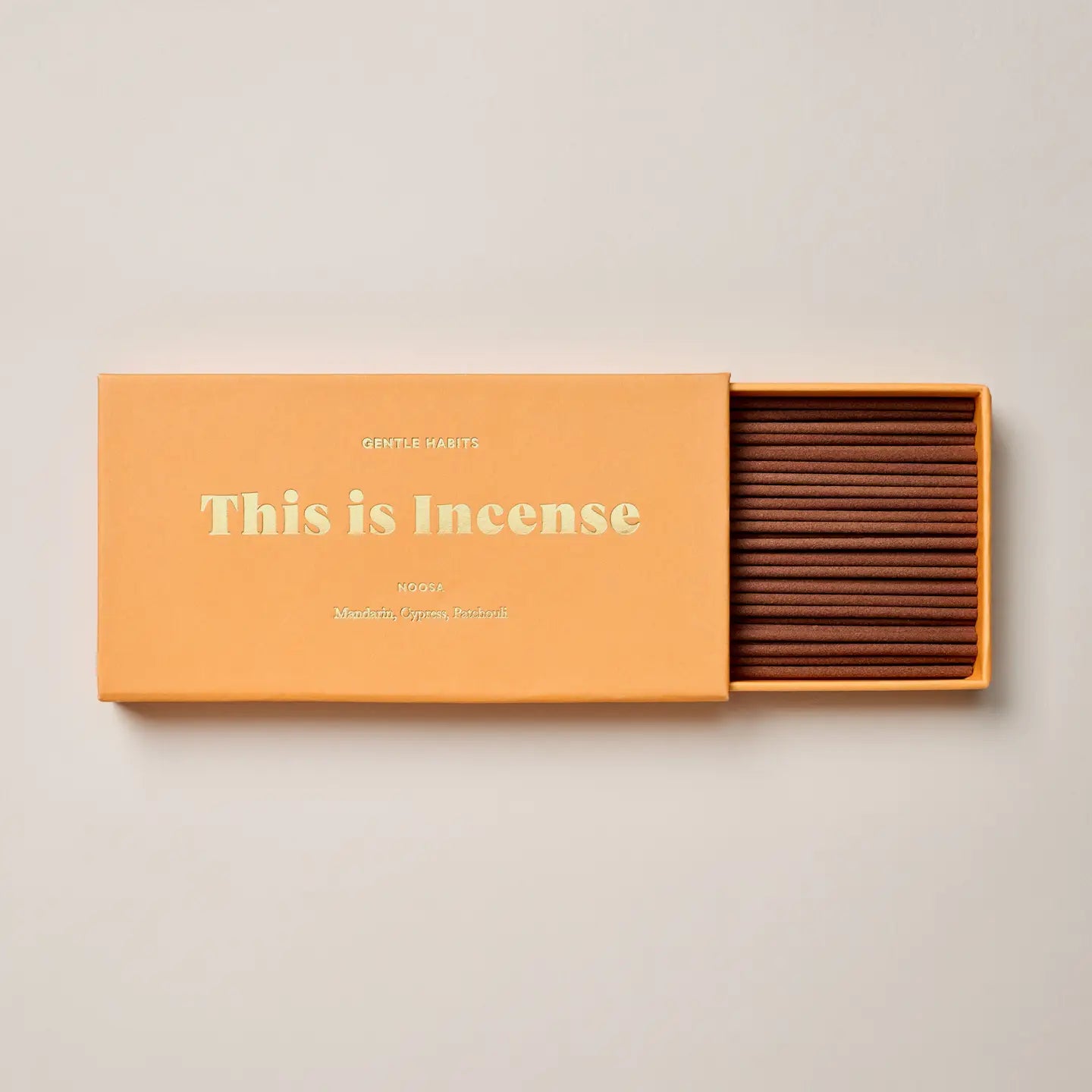 Citrus orange Noosa incense packaging on neutral background