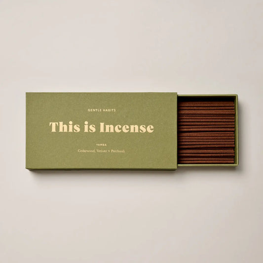 “Yamba incense packaging leaning on a textured white stone block”