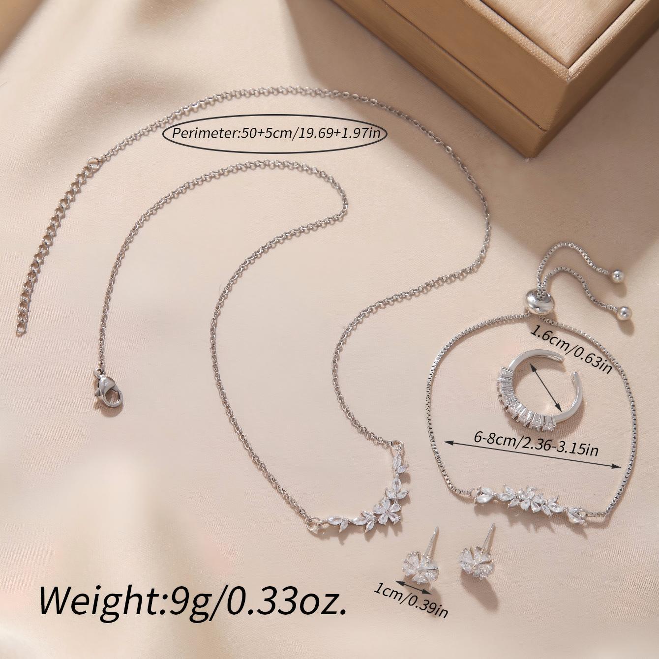 “Elegant silver zircon necklace, bracelet, ring and earrings styled together for a coordinated jewelry look”