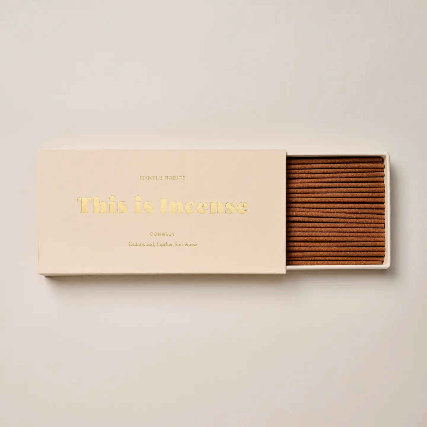 “Connect incense box in cream color shown partially opened with incense sticks”