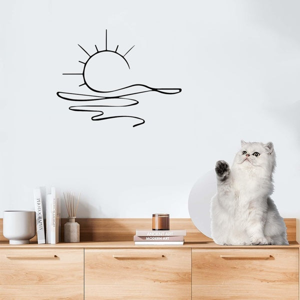 black metal sunrise artwork displayed on beige wall